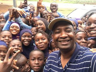 Lamin Bah Takes Photos with Sierra Leone School Children